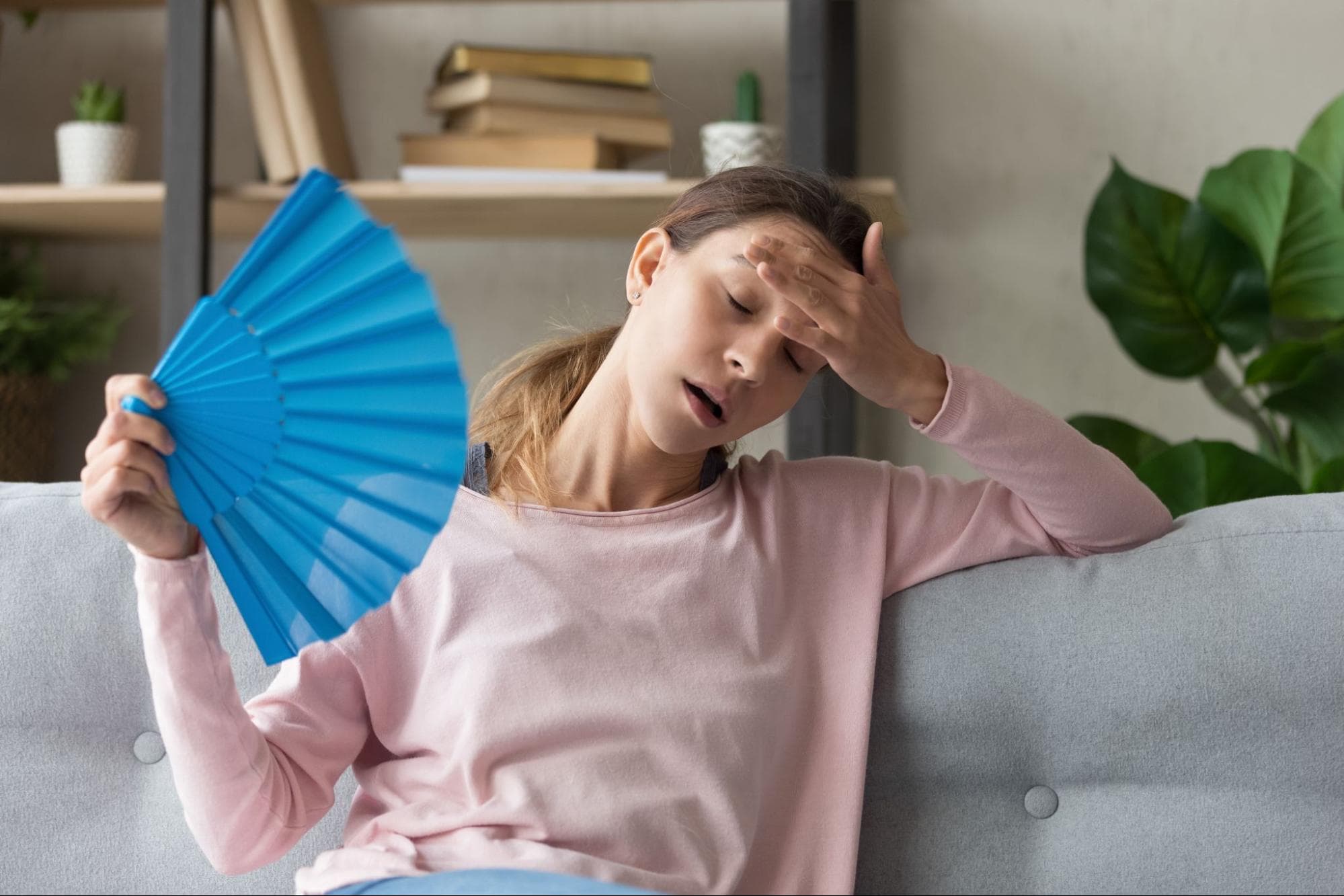 women sitting in hot home with broken AC fan